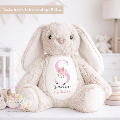 May include: A soft beige bunny toy with long ears and embroidered eyes and nose. The bunny features a pink letter &amp;quot;S&amp;quot; on its chest, with the name &amp;quot;Sadie&amp;quot; and the words &amp;quot;Big Sister&amp;quot; underneath. The text &amp;quot;Newborn Safe: Embroidered Eyes &amp; Nose&amp;quot; is at the top.