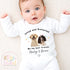 May include: White baby bodysuit with long sleeves, featuring the text "Loved and Protected By my best friends Marley & Bruno". The design includes illustrations of a yellow Labrador and a brown and white Springer Spaniel.